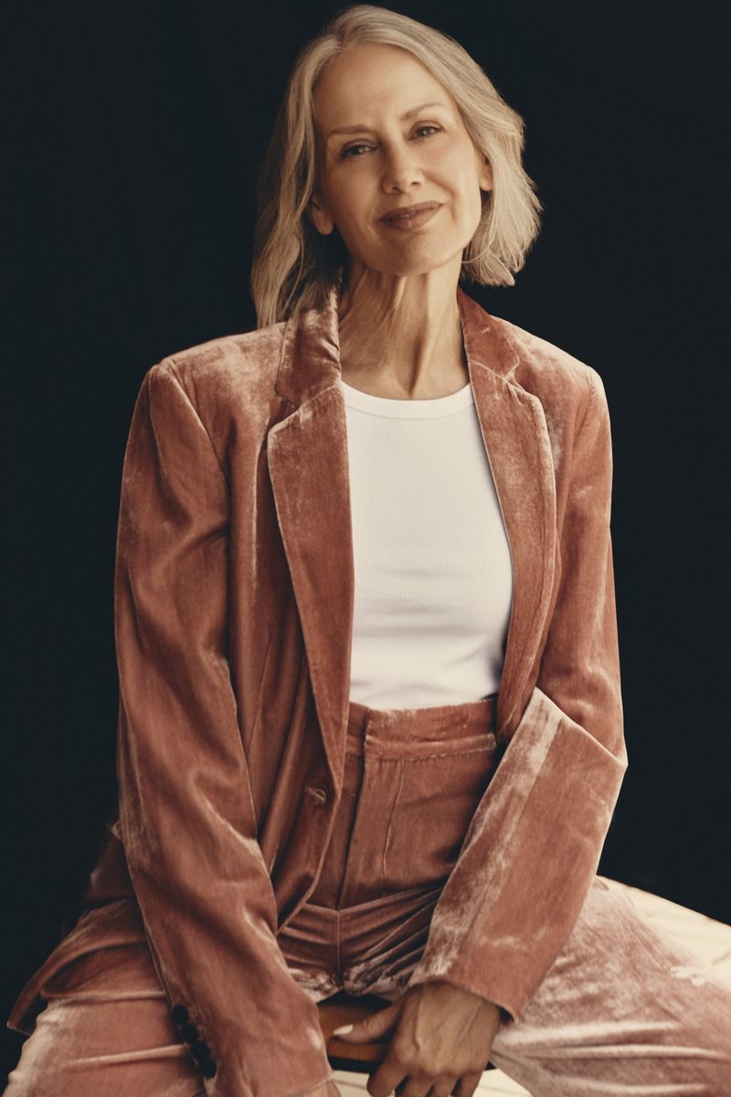 Samantha Foreman seated in a dusty-rose crushed-velvet suit