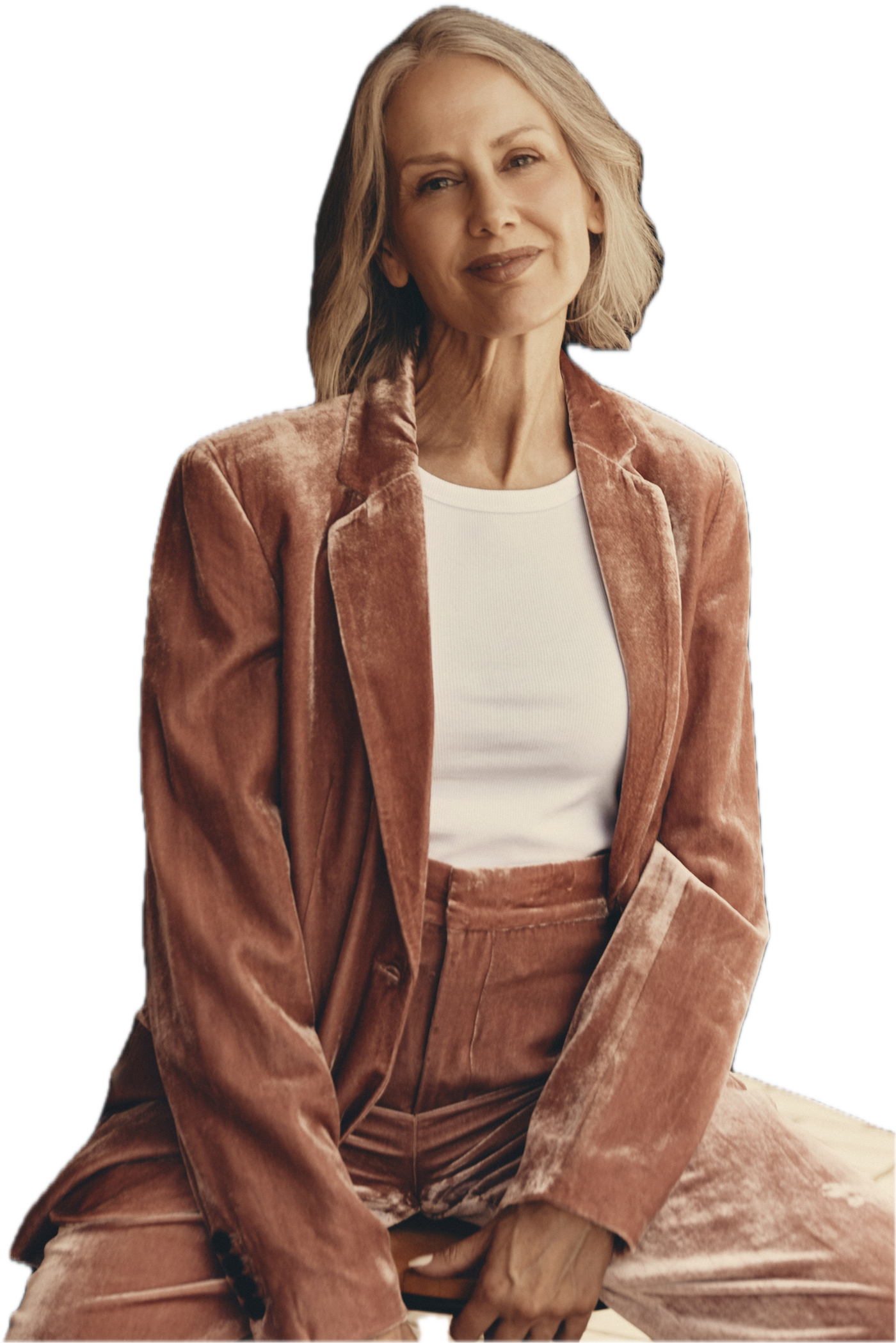 Samantha Foreman seated in a dusty-rose crushed-velvet suit